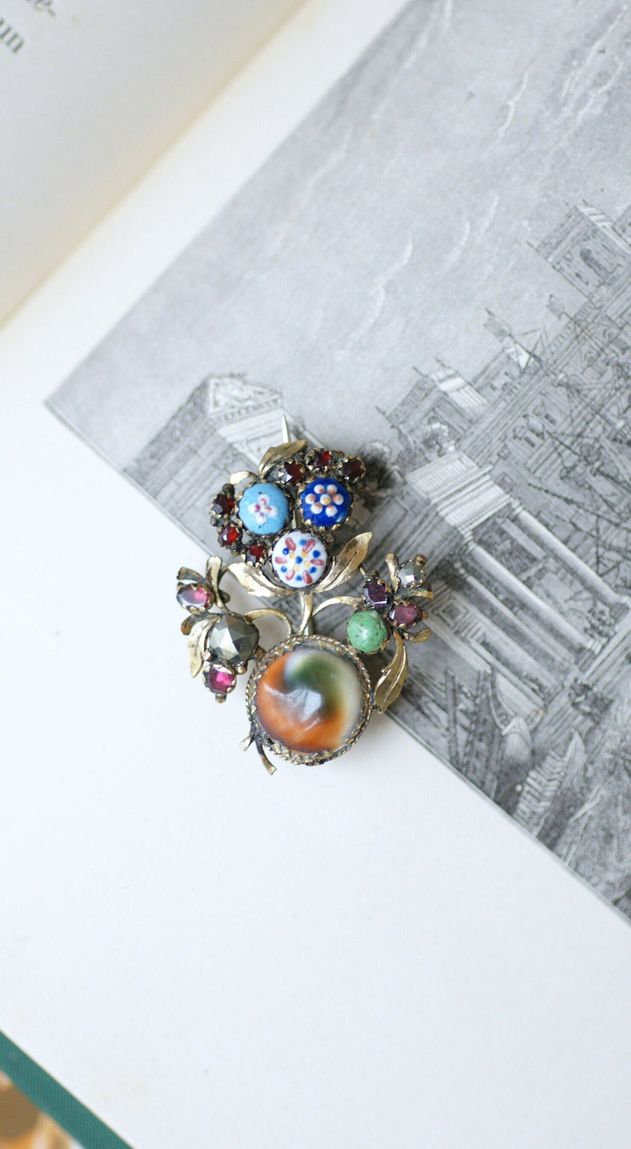 Antique metal brooch with miniatures and red stones, 18th century